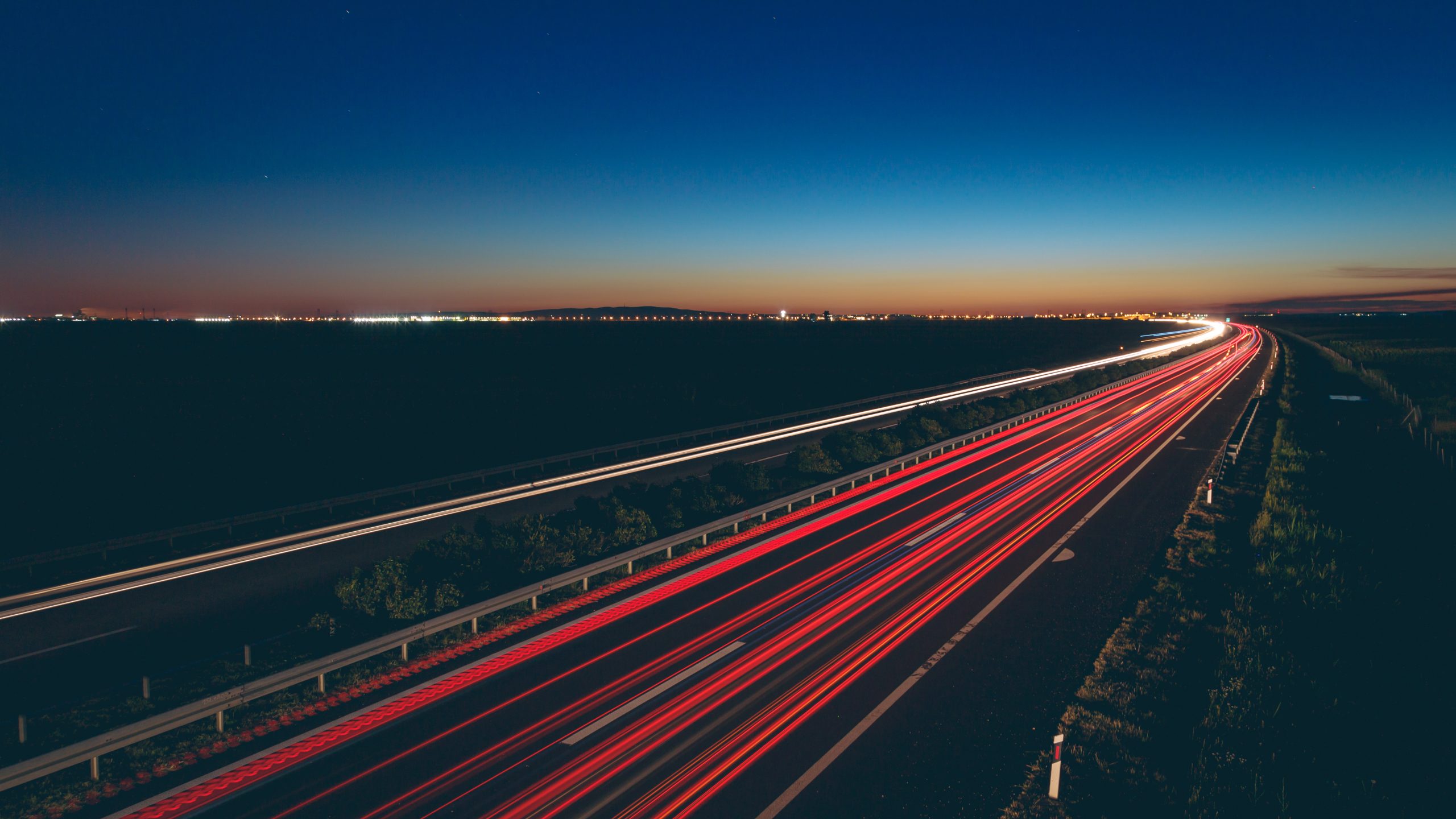 A beautiful view of transportation lights on the road at night time